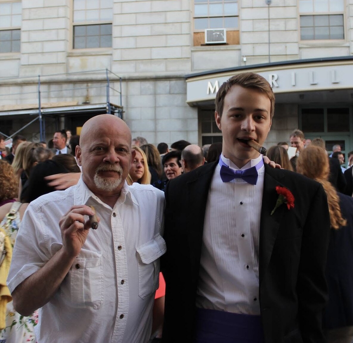 David and a young man smiling together at a formal event