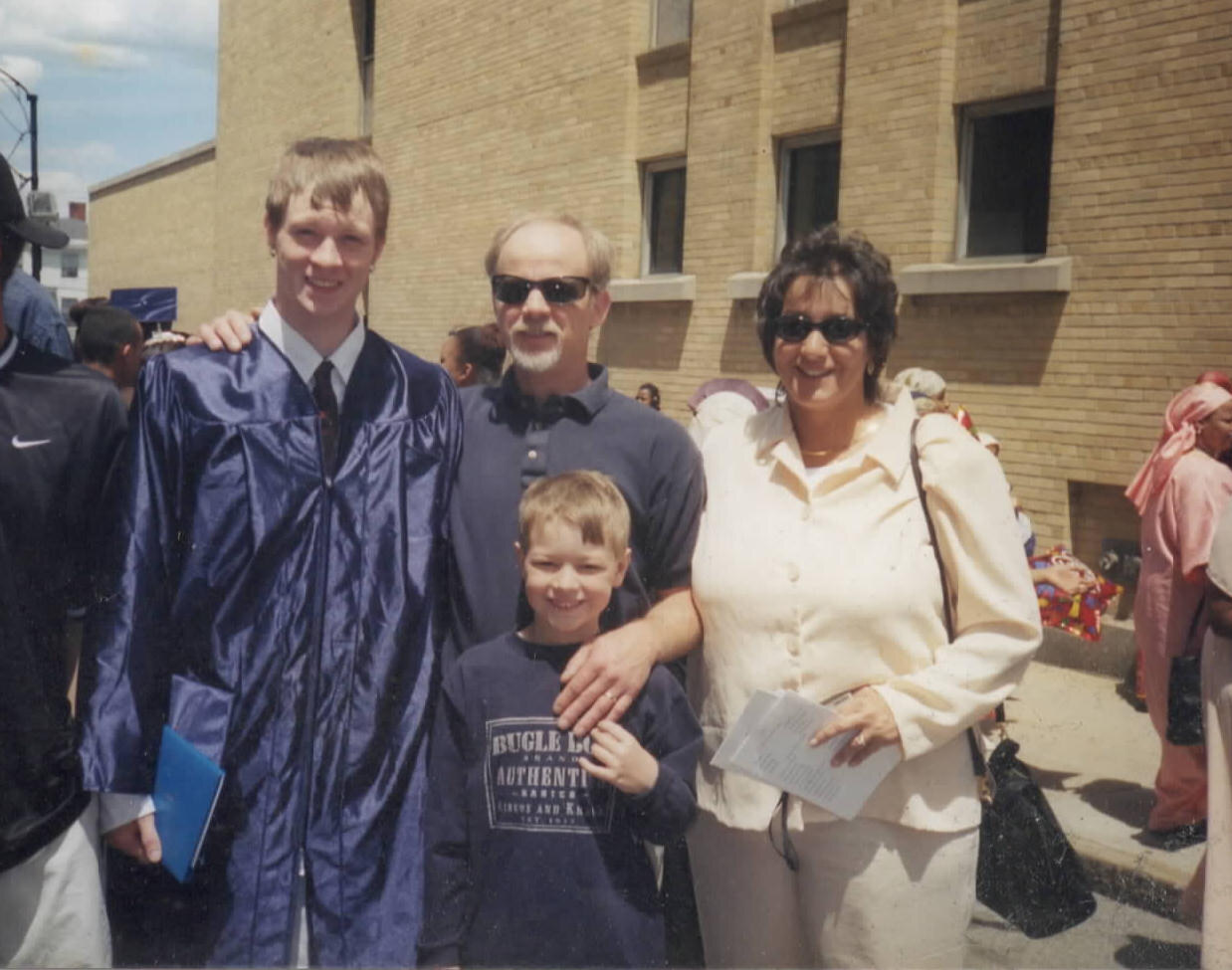 Family gathered outdoors at a graduation