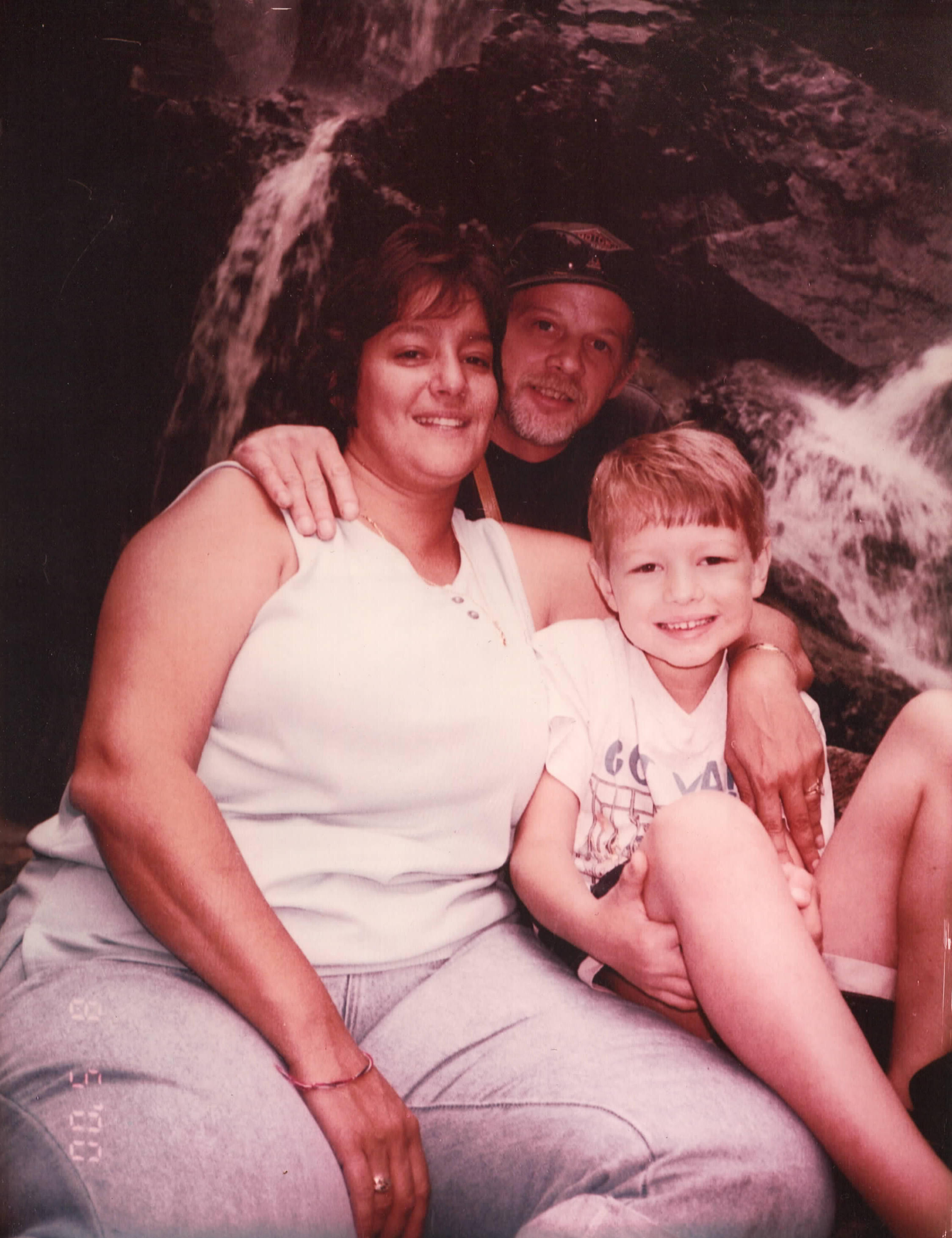 Andrea, David, and young Zachary in a family photo
